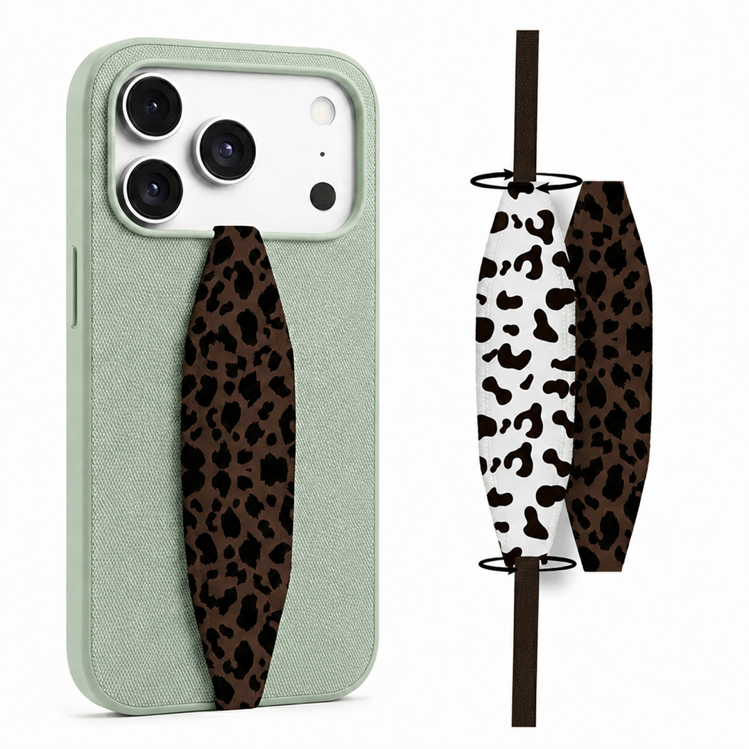 Animal theme phone grip strap attached to smartphone case, held securely in hand Animal theme phone grip strap attached to smartphone case, held securely in hand