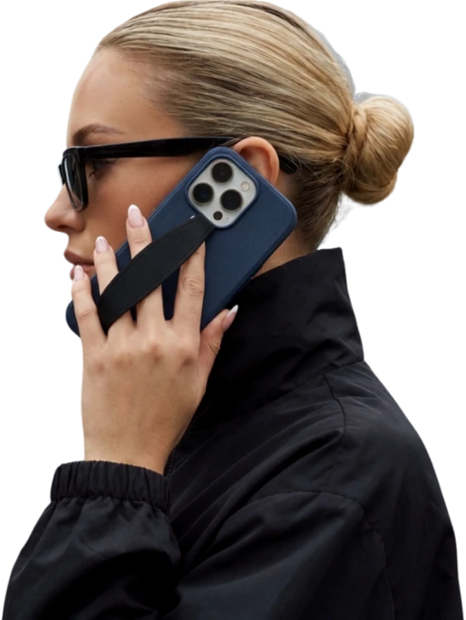 Woman on a call holding phone with ECITWEB grip strap